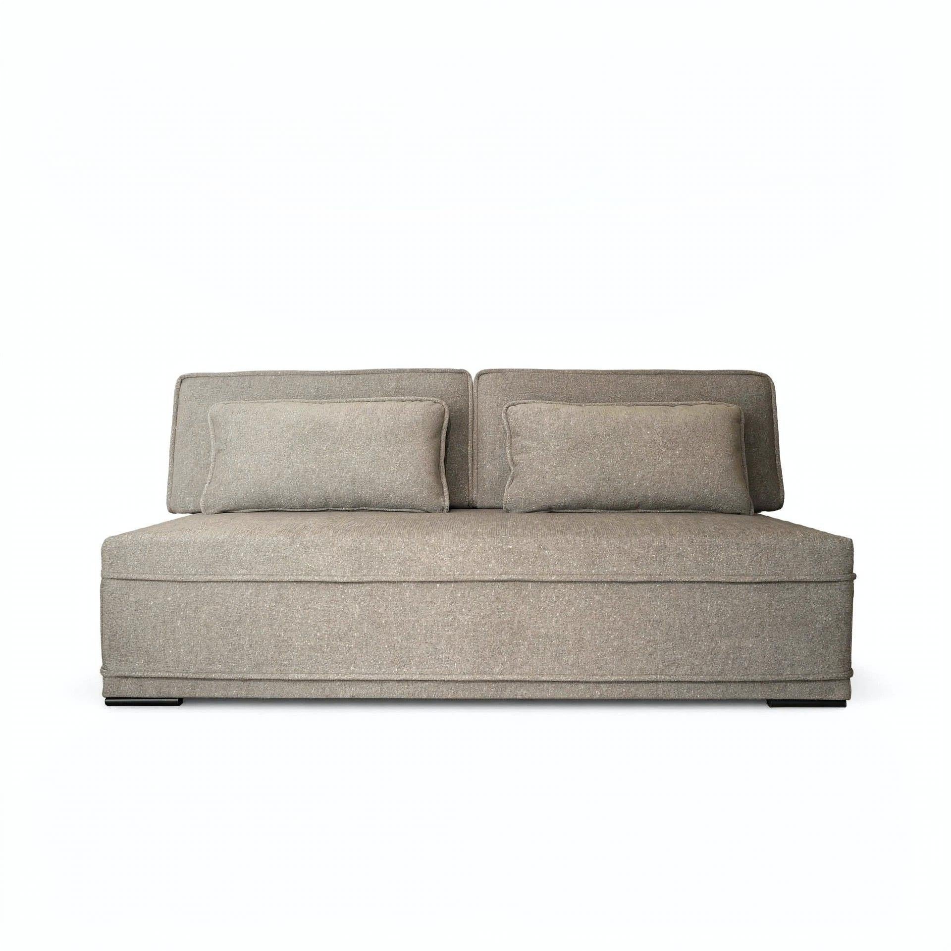 A modern low-profile loveseat sofa upholstered in a textured taupe fabric, featuring two matching square throw pillows, shown against a plain white background.