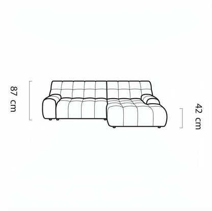 Black line drawing of a tufted sectional sofa on a white background, with dimension labels showing 87 cm height and 42 cm depth.