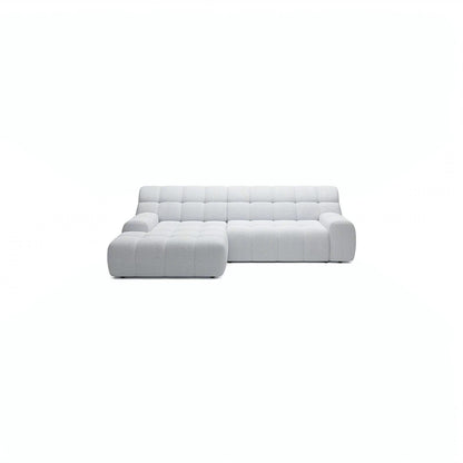 A modern light gray tufted sectional sofa with a left-facing chaise lounge, shown against a solid white background.