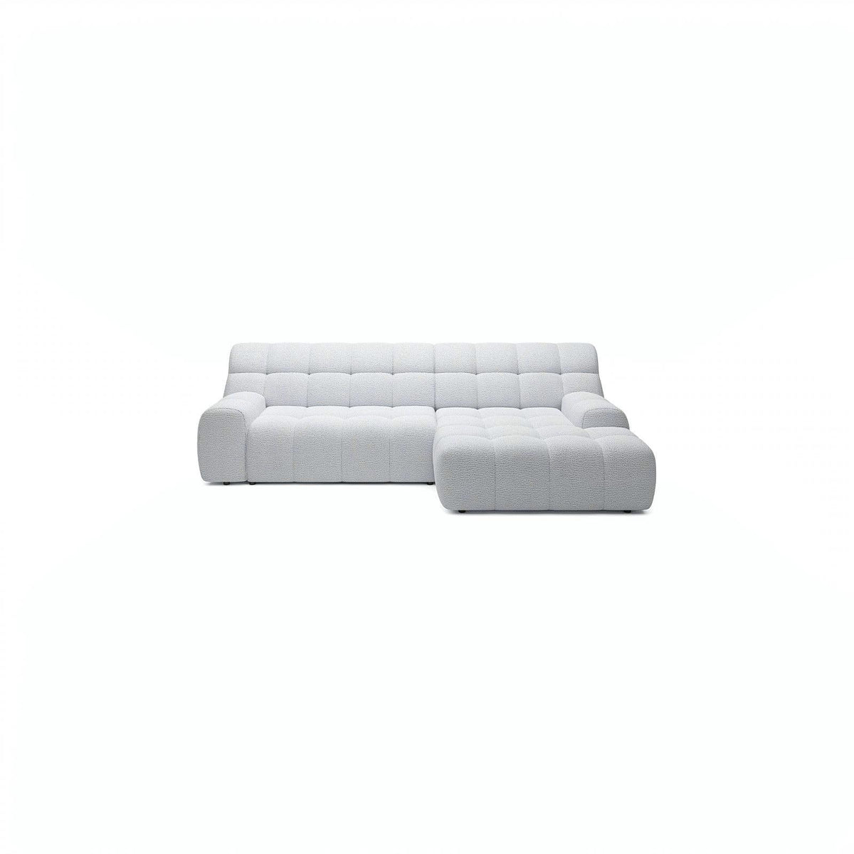 A modern light gray tufted sectional sofa with a right-facing chaise lounge, shown against a solid white background.