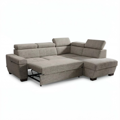A beige upholstered sectional sofa with a chaise lounge and reclining seat section, shown on a plain white background.