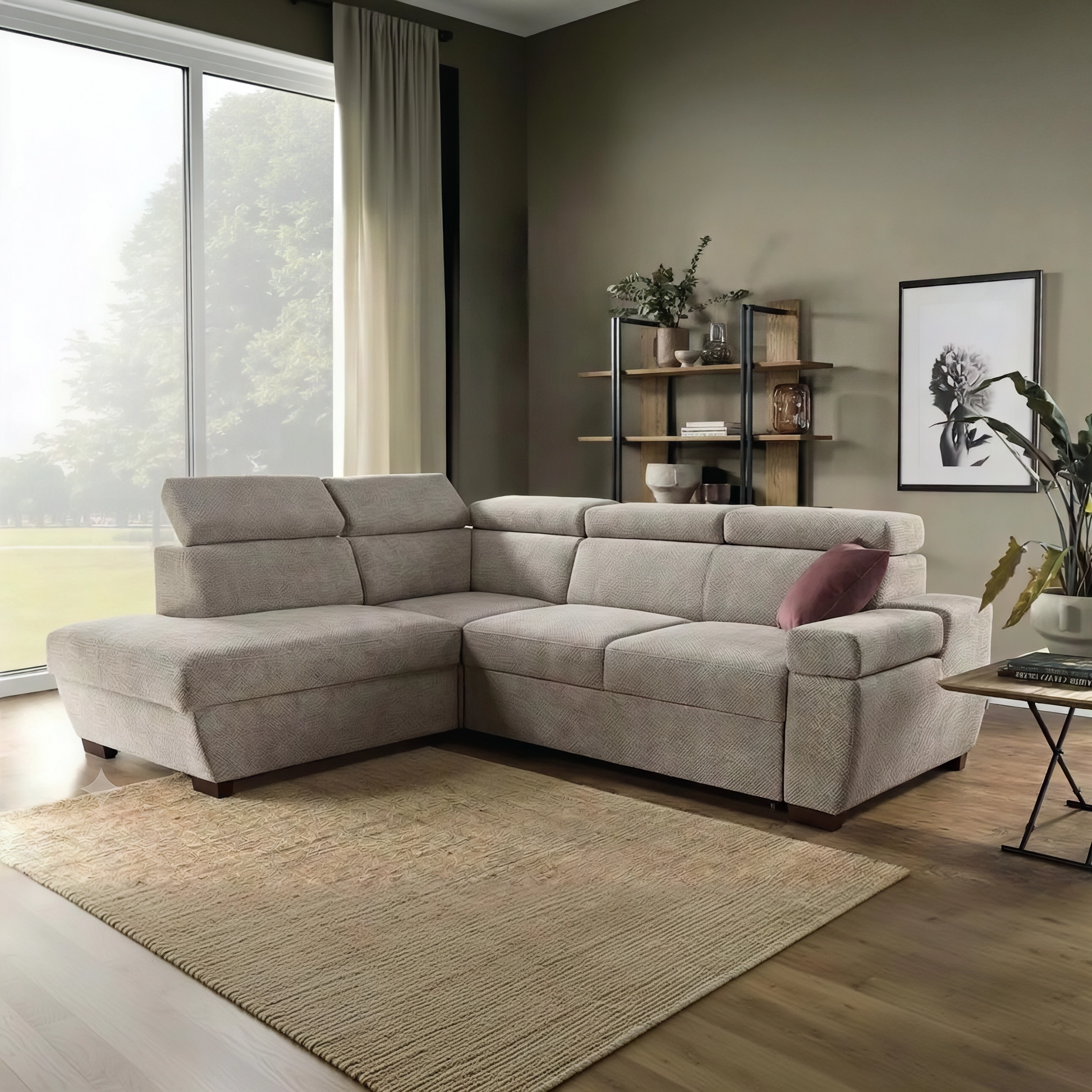 A beige fabric sectional sofa with a left-facing chaise lounge, styled in a modern living room with a woven area rug, wooden floor, and shelving.