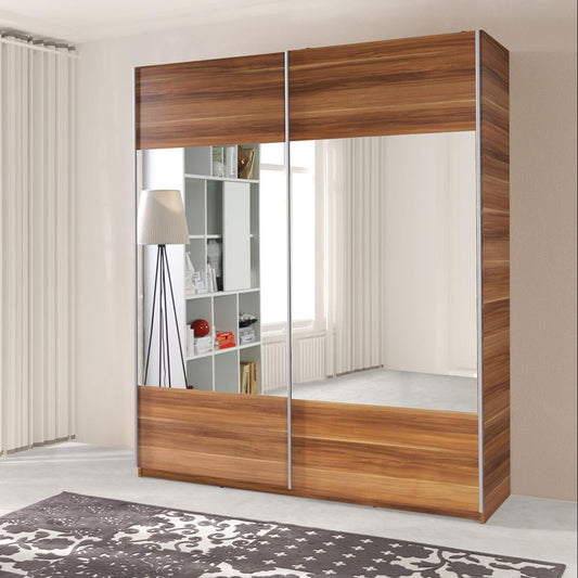 Modern sliding door wardrobe with mirror and shelves, in a room with minimalist decor.