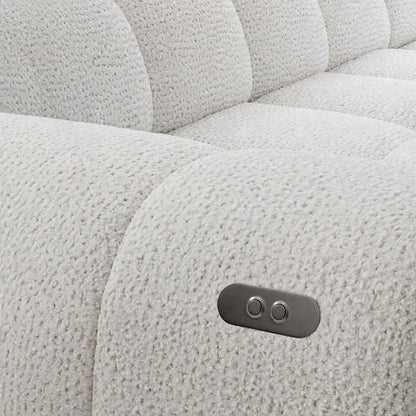 Close-up of a light grey textured sofa armrest featuring a metallic control panel for seat adjustment.